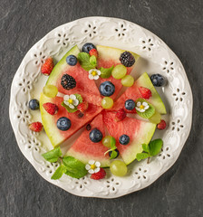 Fruit watermelon pizza with fresh berries and mint