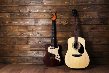 Naklejka premium Electric and acoustic guitars on wooden background