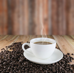 White coffee cup and roasted coffee beans.