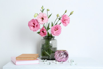 Beautiful flowers with books on wall background