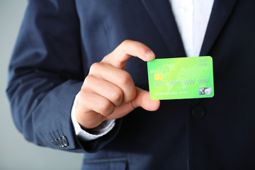 Businessman holding credit card,  close-up