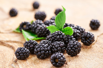 Handful blackberries on a stone surface