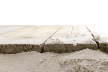 Sand with wooden planks isolated on white