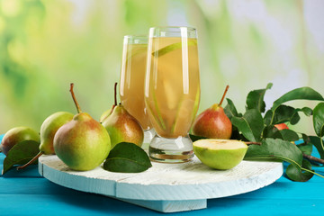 Fresh pear juice with fruit on bright background