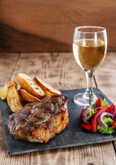 pork steak with fried potatoes and salad