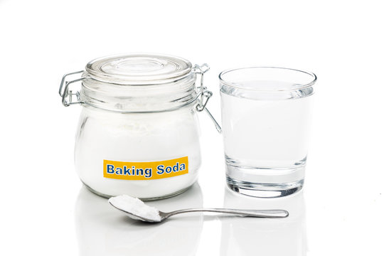Baking soda in jar, spoonful and glass of water for multiple hol