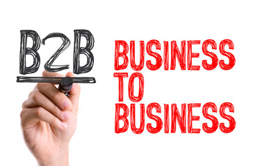 Hand with marker writing the word Business to Business