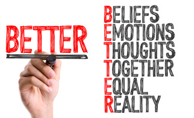Hand with marker writing the word BETTER Acronym