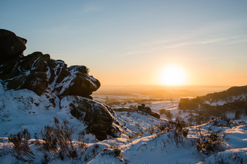 Sunset from the snow covered Ramshaw Rocks looking over the Staffordshire Moorlands, UK