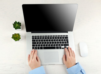 Hands working in the office with laptop on white table