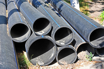 Stacked new PVC pipe on construction site