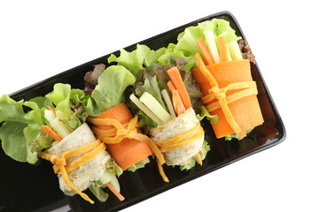 roll salad in the black dish on white.