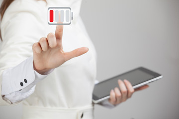 Woman holding tablet and pen, battery level icon