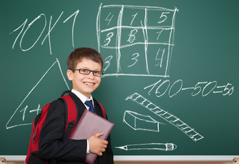 school boy with drawing on board
