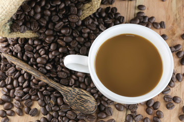 White coffee cup and roasted coffee beans.