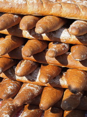 Fototapeta na wymiar A pile of freshly baked bread in an outdoor market stall.
