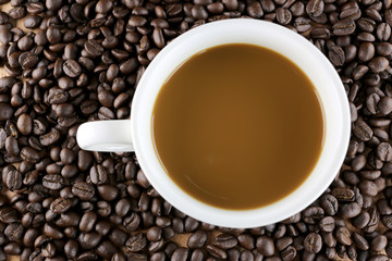 White coffee cup and roasted coffee beans.