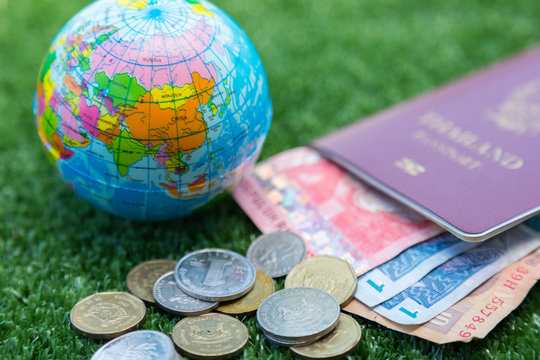Photo of passport, money and world map.