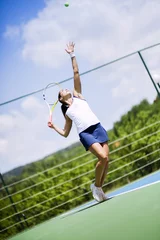 Fototapeten Beautiful female tennis player serving © NDABCREATIVITY