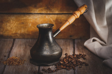 Welded  coffee in cezve on a wooden surface, rustic style