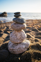 Fototapeta na wymiar Smooth stones stacked on a Pacific beach
