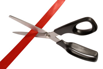 Scissors cutting red ribbon or tape isolated on white background photo