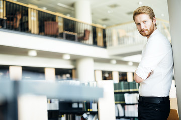 Serious handsome student in library