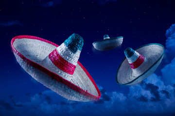 High contrast image of Mexican hats / sombreros in the sky at ni