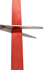 Scissors cutting red ribbon or tape isolated on white background photo vertical