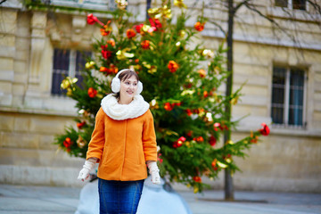 Cheerful young woman in Paris on a winter day