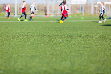 Obraz na płótnie Canvas Blurred kids playing soccer