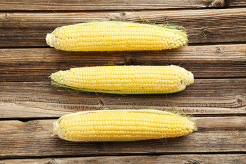 Corns on a brown wooden background