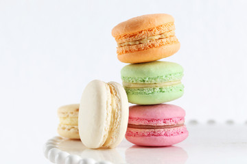 French colorful and tasty macarons on white stand
