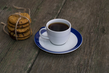 white cup of coffee on a saucer with a blue border