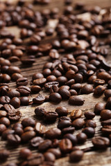 Roasted coffee beans on a brown wooden background