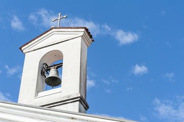 Small bell tower with a bell of a country church 