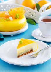 Cake with orange mousse and almond krokantom in the mirror glaze. Selective focus.