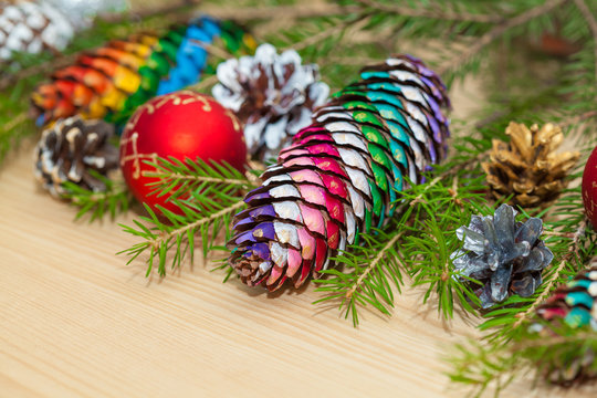 Green Christmas tree with toys. Christmas colorful hand-painted pine cones