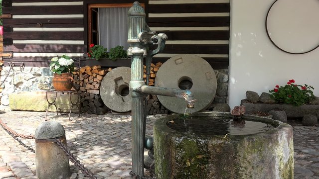 Types of Prague. Retro water taps column in a courtyard (Hradcany). 