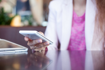 girl holds a smartphone,  small depth of field, soft focus
