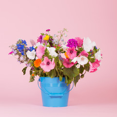 Colorful garden flowers in bucket