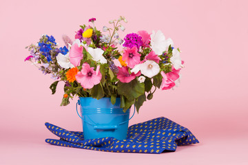Colorful garden flowers in bucket