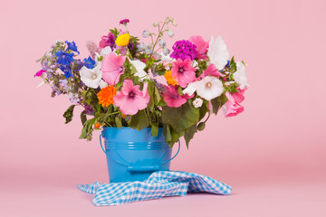 Colorful garden flowers in bucket