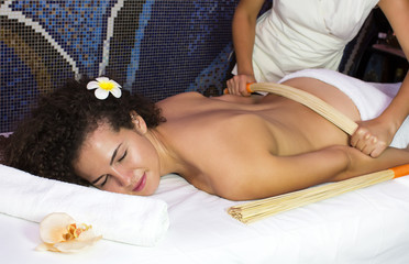 Obraz na płótnie Canvas Japanese massage with bamboo sticks in the spa salon