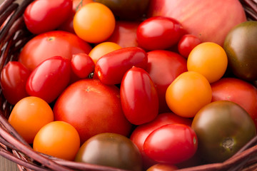 Fototapeta na wymiar Various kinds of tomatoes in basket