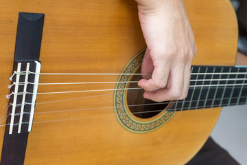 Fototapeta premium Close-up of classical guitar strings wiht fingers 2