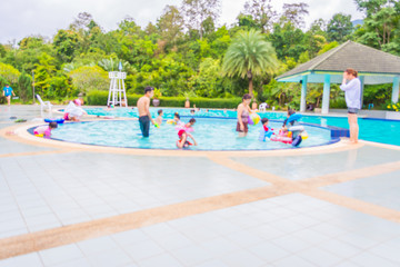image of blur people at swimming pool with bokeh