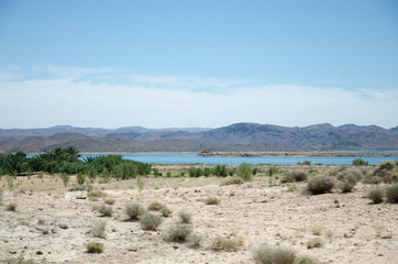 Dry desert land with lake and Atlas mountains