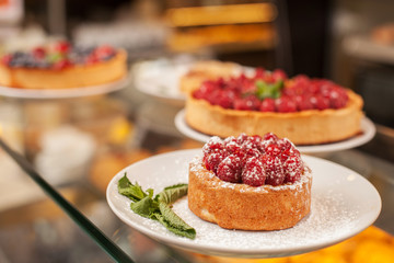 Wide selection of sweet cakes in bakehouse