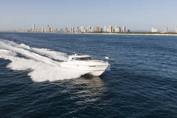 Luxurious boat sailing away from the city